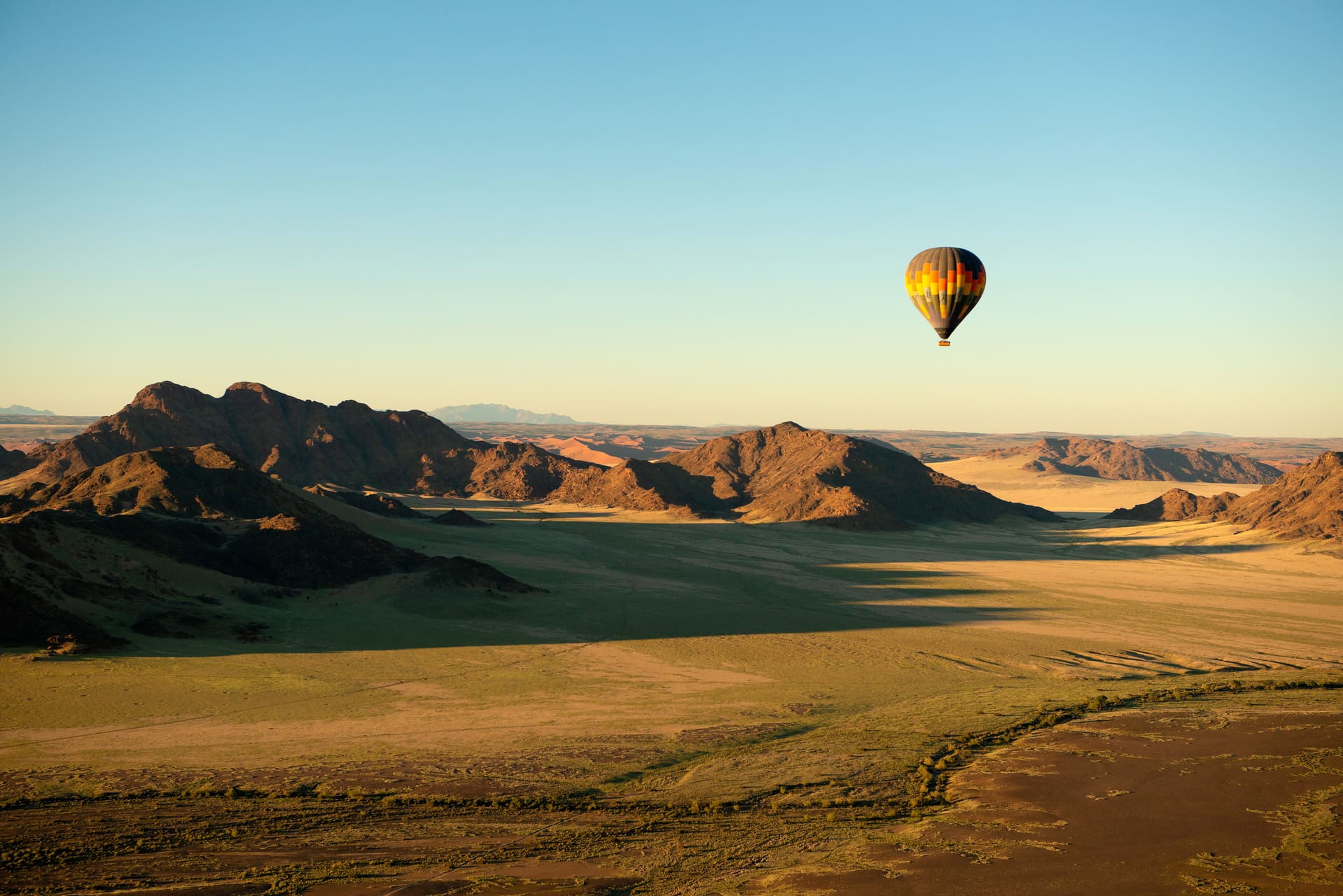 a-hot-air-balloon-flight-over-the-sossusvlei-national-park-landscape-at-sunrise-namibia-AdobeStock_477579616.jpeg