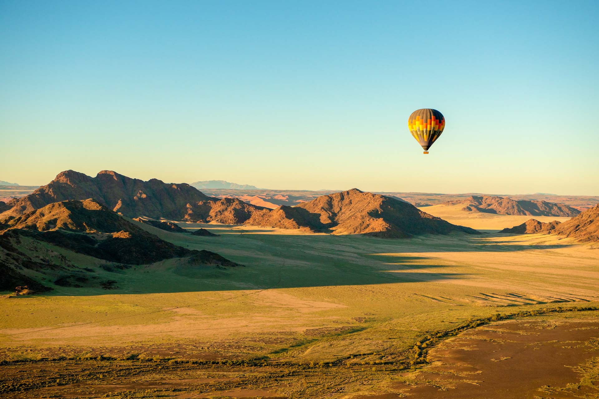 a-hot-air-balloon-flight-over-the-sossusvlei-national-park-landscape-at-sunrise-namibia-AdobeStock_477579616.jpg